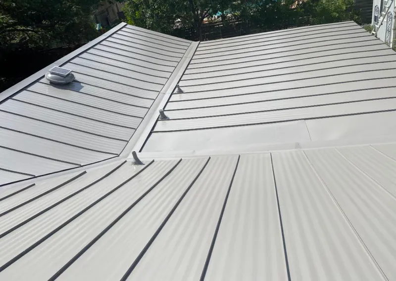 Solar attic fan installed on a metal roof for Roof Ventilation in Somerville